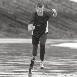 Man running with lower extremity prosthetics